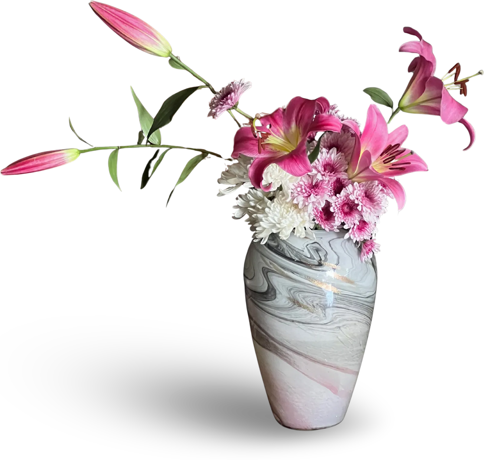 Pink lilies and chrysanthemums in a grey-and-white marbled glass vase, with a soft shadow.